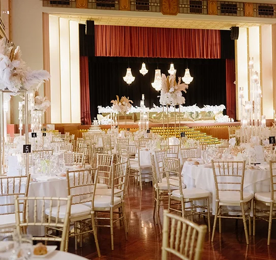 Elegant wedding catering setup with white floral centrepiece and plated meals in Melbourne 